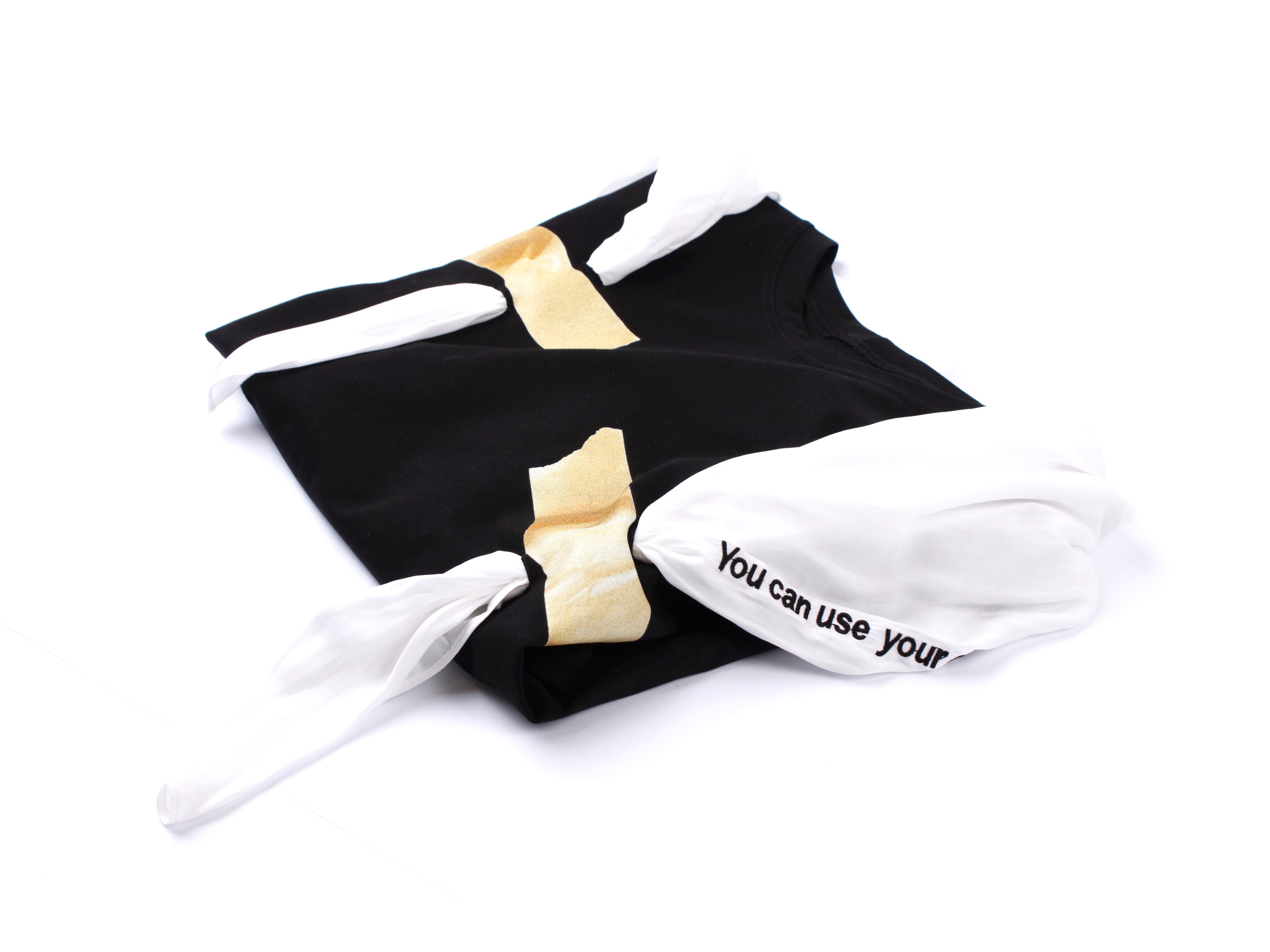 Black t-shirt with a taped white scarf
